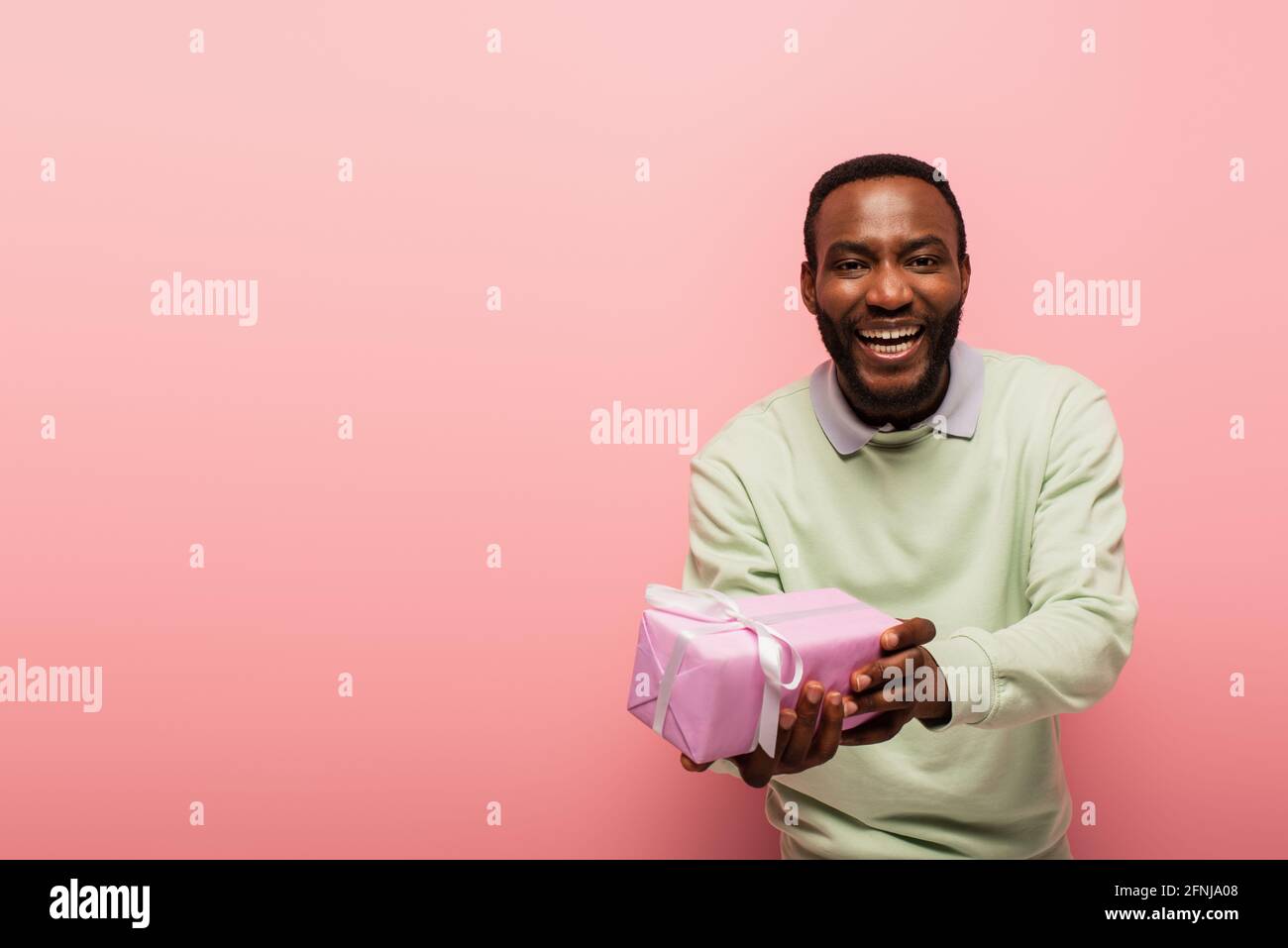 Surprised young african man showing hi-res stock photography and images ...