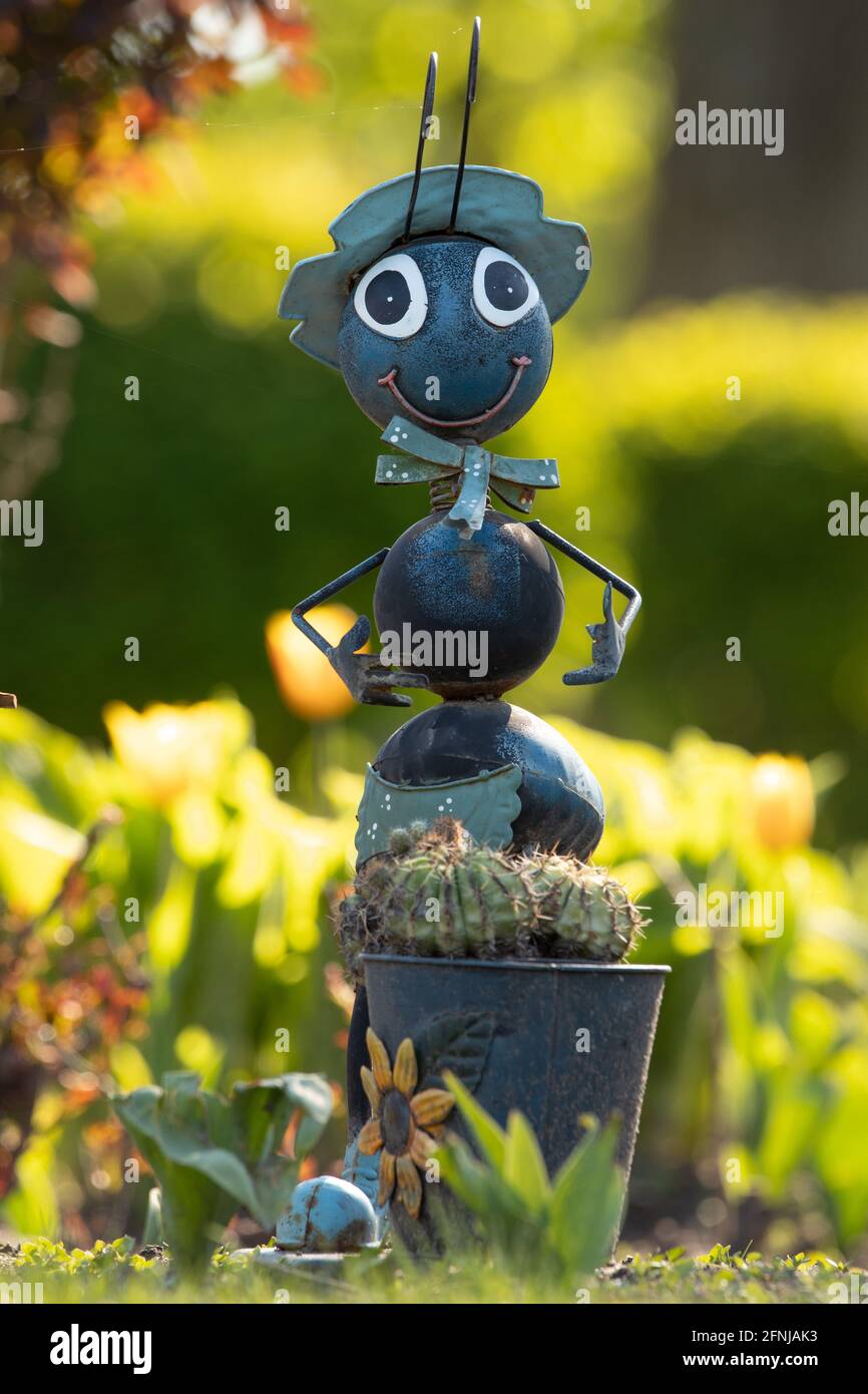 Metal ant, gray garden toy. For decorating flower beds. Stock Photo