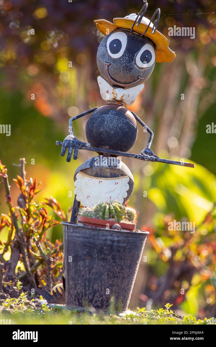 Metal ant, gray garden toy. For decorating flower beds. Stock Photo