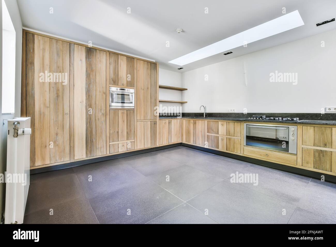 Spacious kitchen with wooden furniture Stock Photo