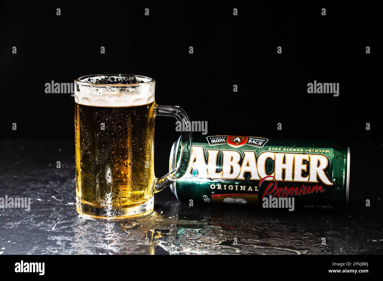 Can of Albacher beer and beer glass on dark background. Illustrative ...