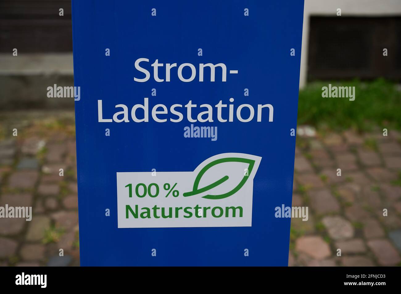 Speyer, Germany - May 01, 2021: German sign in the city of Speyer, the words mean in English: 'Power charging station, 100 percent natural power' Stock Photo