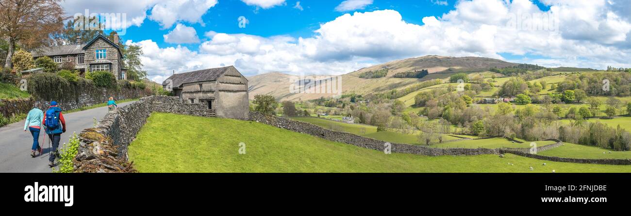 People walking along a quite country lane towards Troutbeck village in the Lake District. Stock Photo