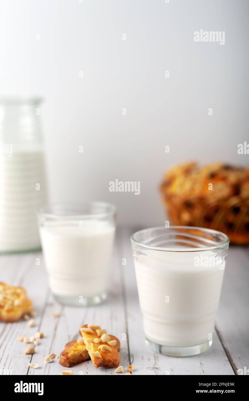 On a light background, milk with freshly baked homemade cookies with peanuts Stock Photo