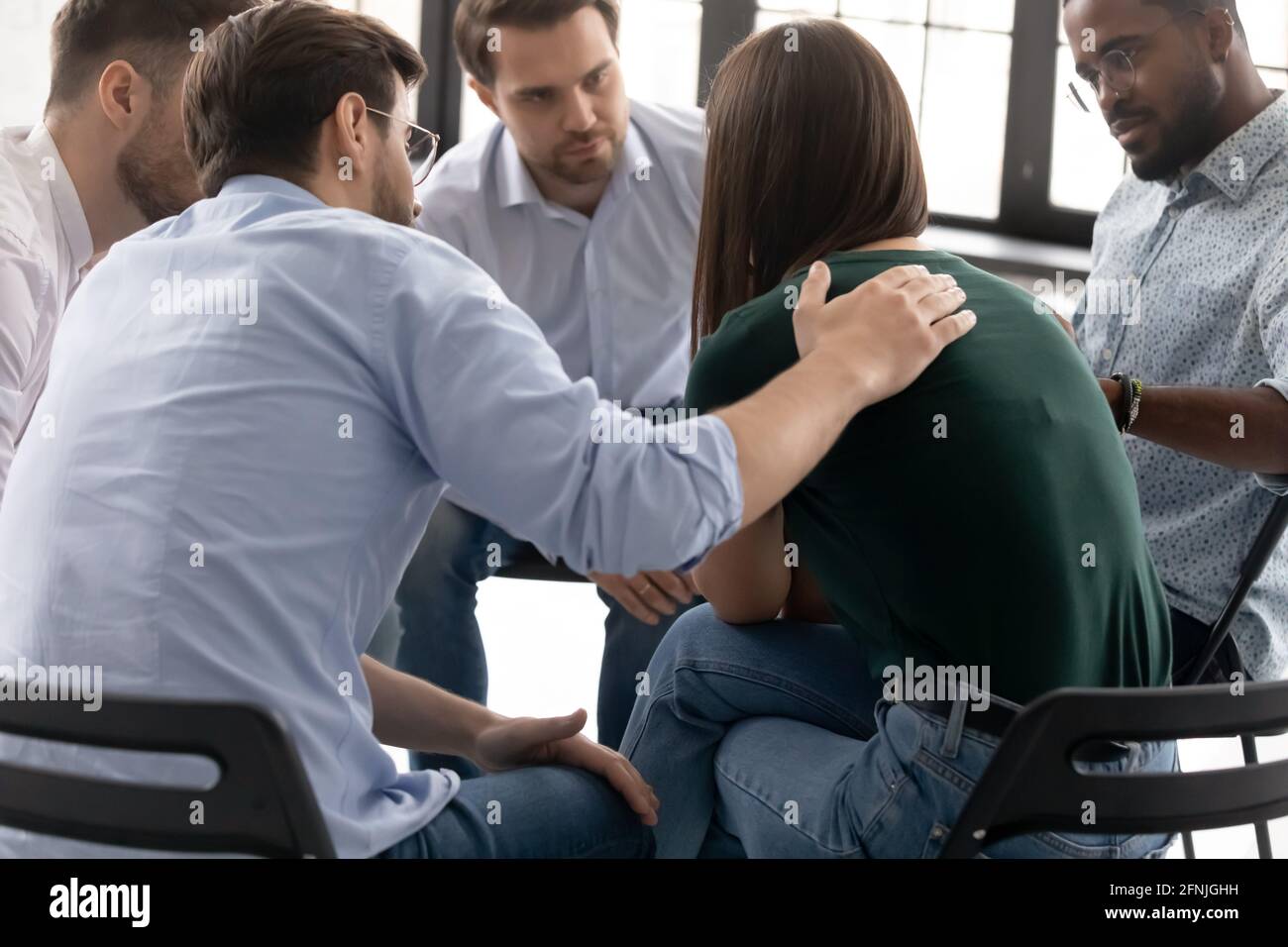 Desperate crying girl sharing sad experience with group mates Stock Photo