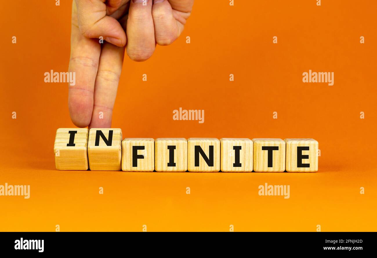 Finite or infinite symbol Businessman turns wooden cubes and changes