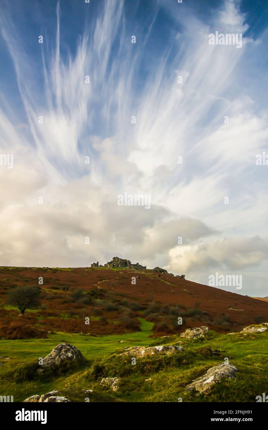 High cirrus clouds appear over Hound Tor on Dartmoor, England Stock