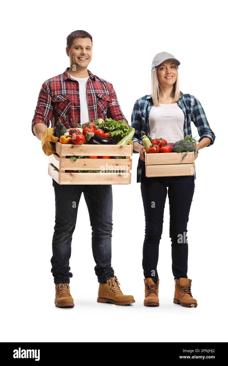 Full length portrait of a young man and woman holding crates full of ...