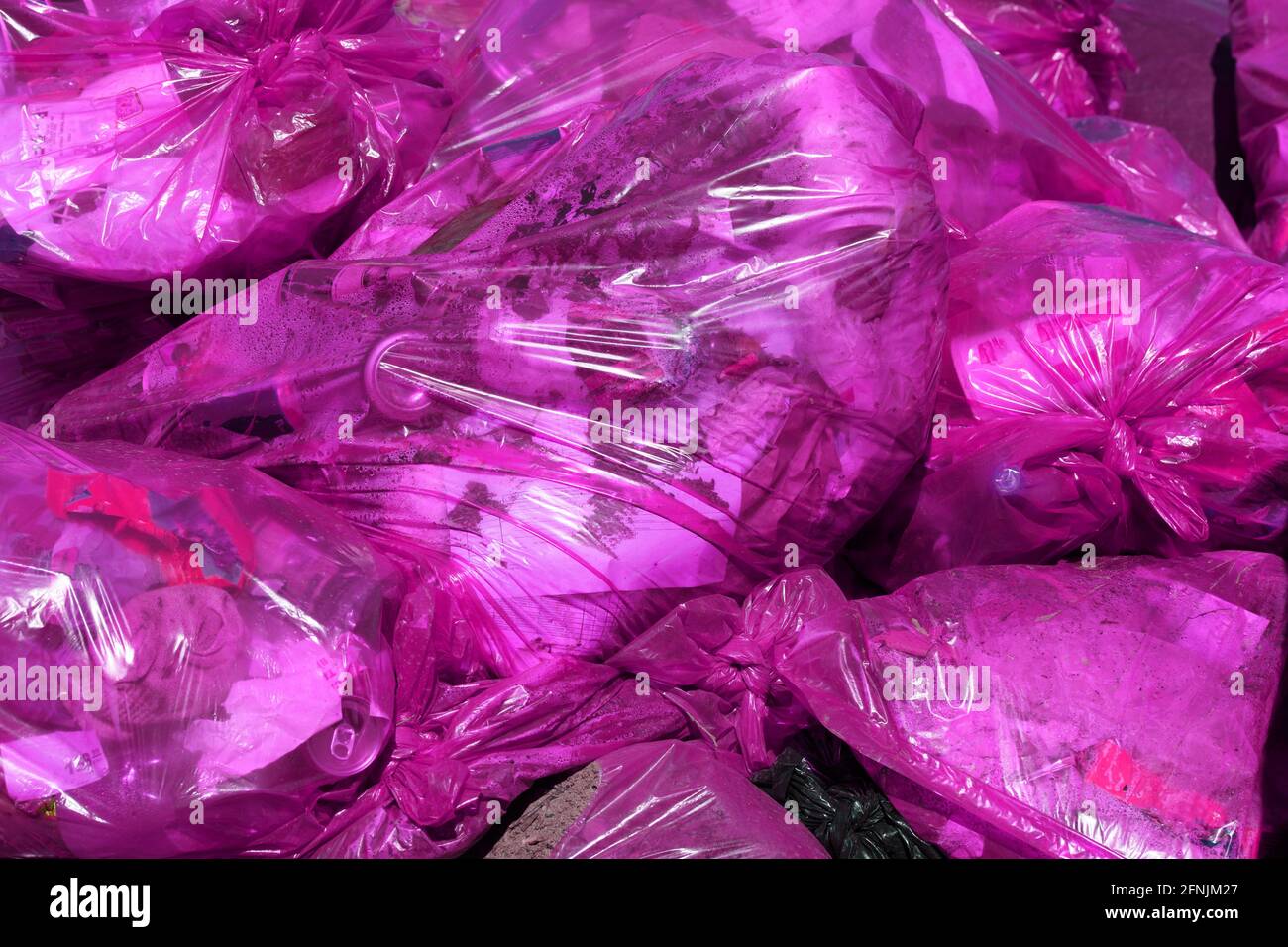 https://c8.alamy.com/comp/2FNJM27/full-frame-background-of-purple-plastic-trash-bags-with-generic-domestic-waste-2FNJM27.jpg