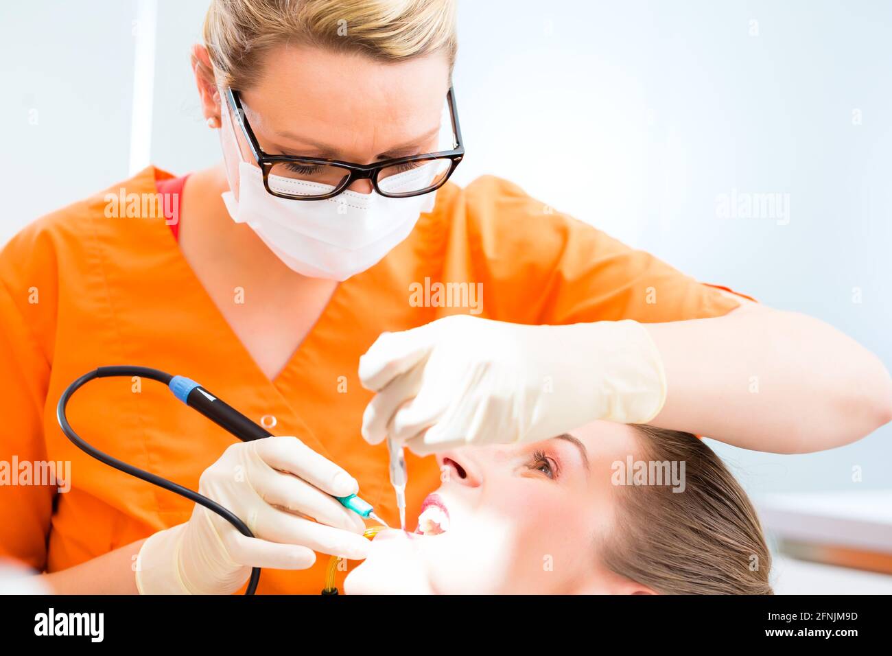 Patient having dental tooth cleaning at dentist Stock Photo Alamy