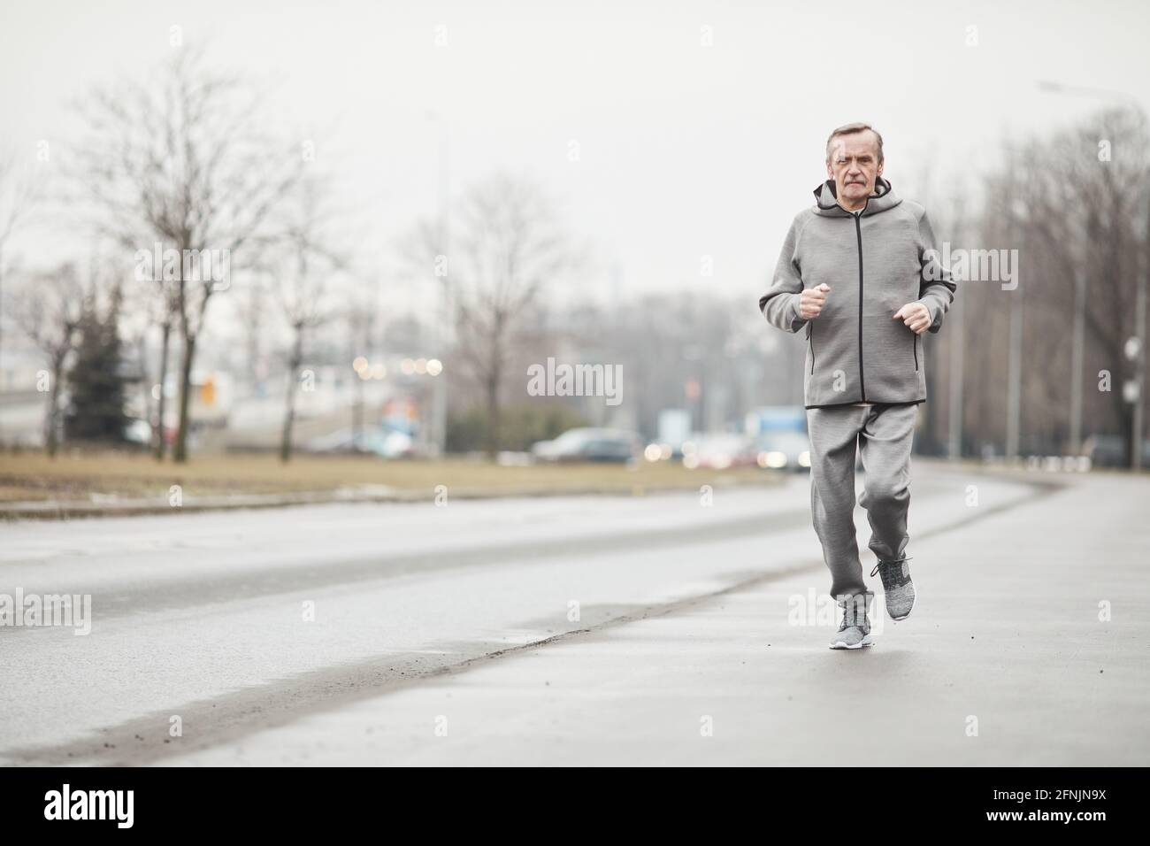 Senior man walking along winter hi-res stock photography and images - Alamy
