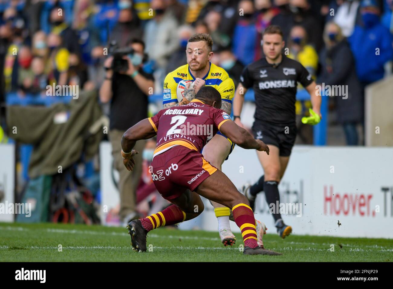 Warrington, UK. 17th May, 2021. Josh Charnley (5) of Warrington Wolves is tackled by Jermaine McGillvary (2) of Huddersfield Giants in Warrington, United Kingdom on 5/17/2021. (Photo by Simon Whitehead/News Images/Sipa USA) Credit: Sipa USA/Alamy Live News Stock Photo