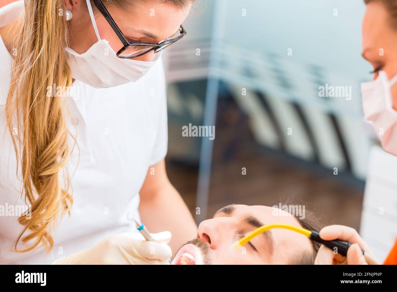 Patient having dental deep tooth cleaning at dentist Stock Photo Alamy