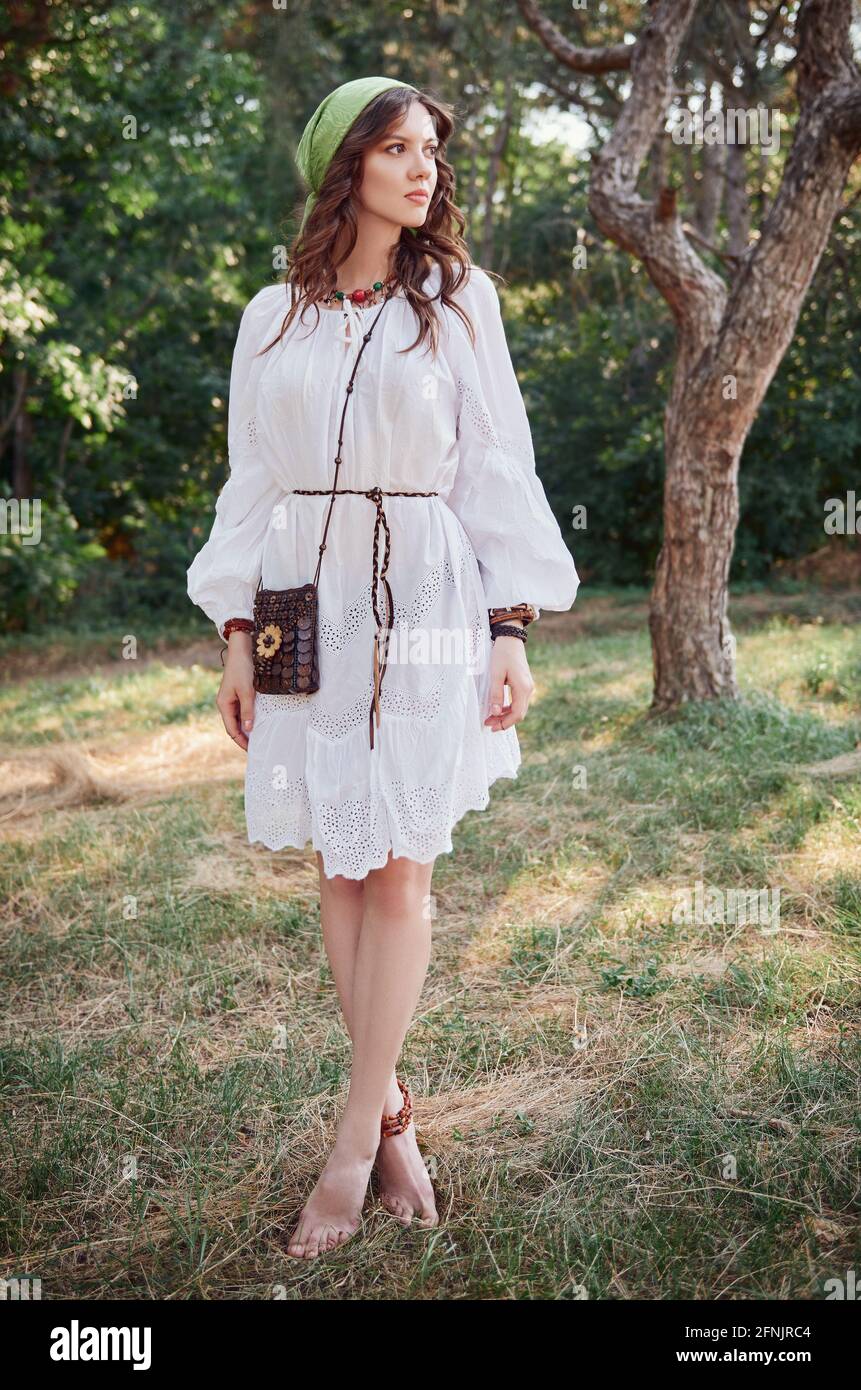 Outdoor fashion: the beautiful young boho (hippie) girl in grove (forest).  Portrait of sweet hippy woman in white dress Stock Photo - Alamy