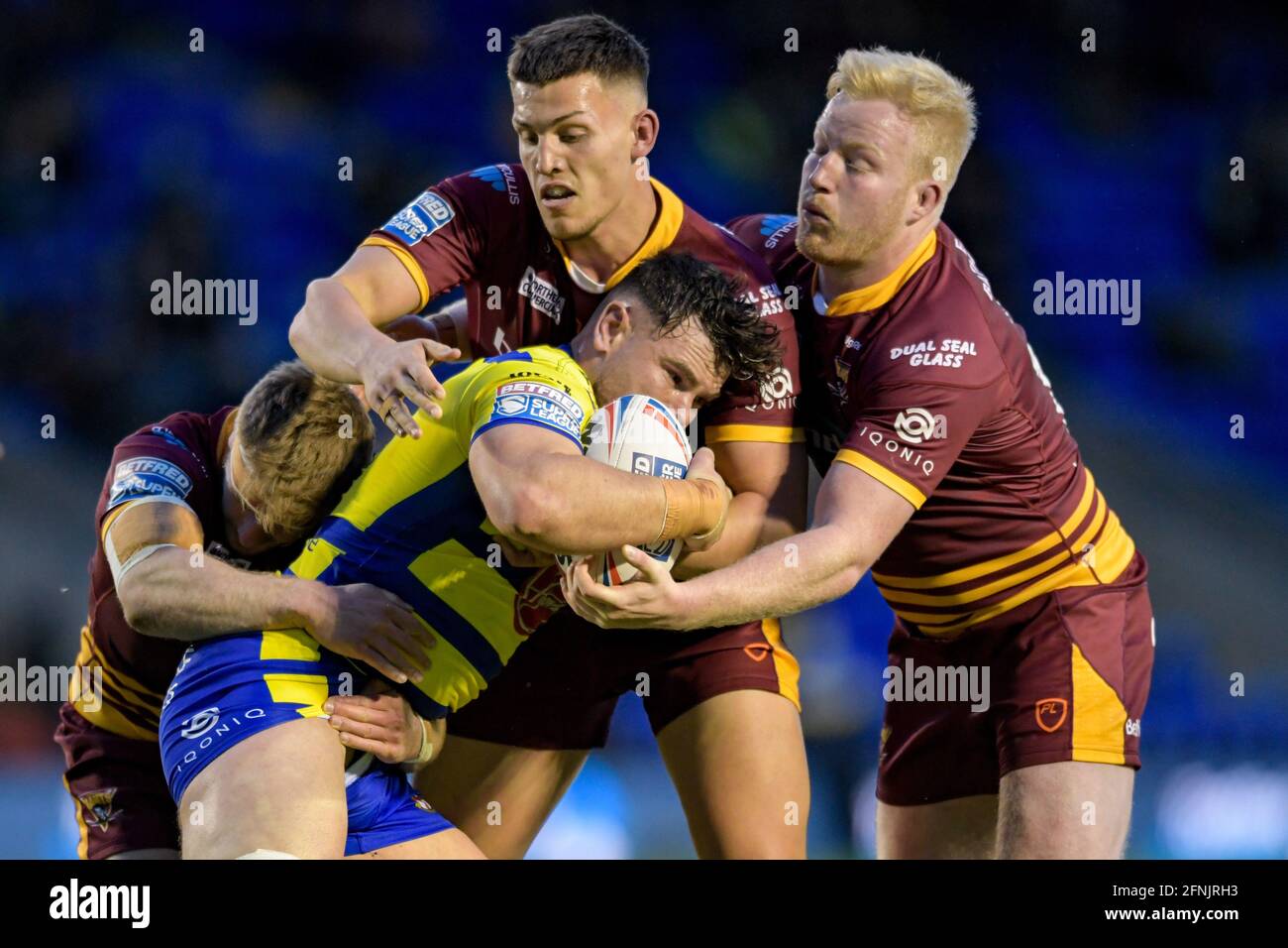 Warrington, UK. 17th May, 2021. Joe Philbin (13) of Warrington Wolves is tackled by Matty English (14) of Huddersfield Giants Owen Trout (25) of Huddersfield Giants and Adam O'Brien (9) of Huddersfield Giants in Warrington, United Kingdom on 5/17/2021. (Photo by Simon Whitehead/News Images/Sipa USA) Credit: Sipa USA/Alamy Live News Stock Photo