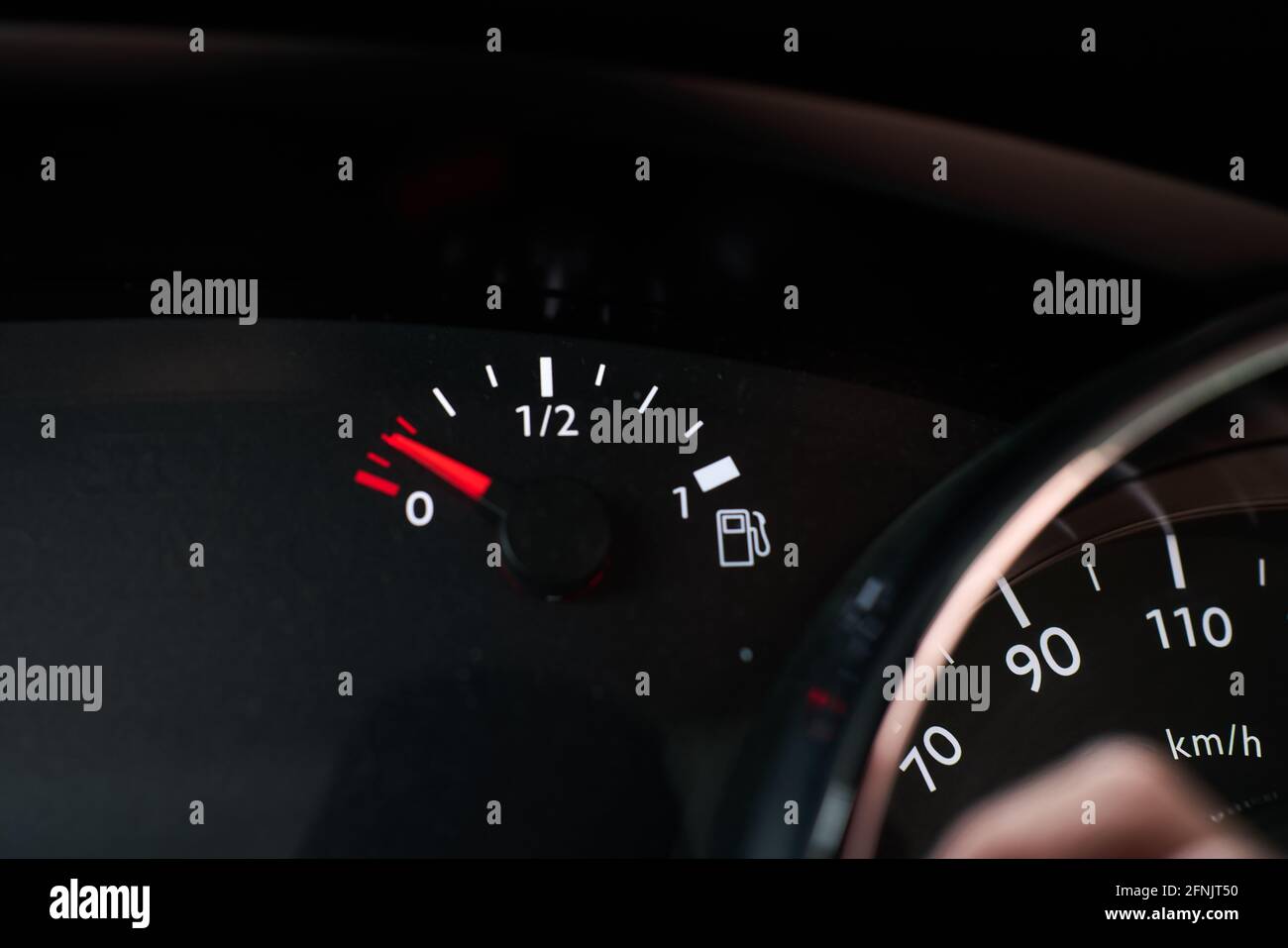 Dashboard of a car indicating that it is running out of fuel reserve
