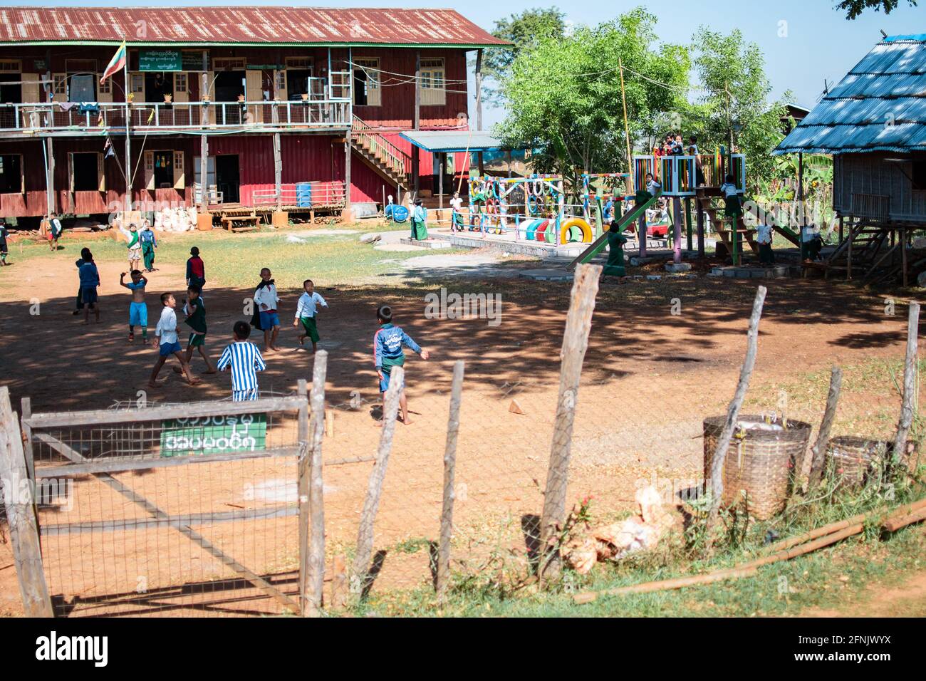 Shan state, Myanmar - January 7 2020: Kids plays outside on a playground of a rural school near Inle Lake Stock Photo