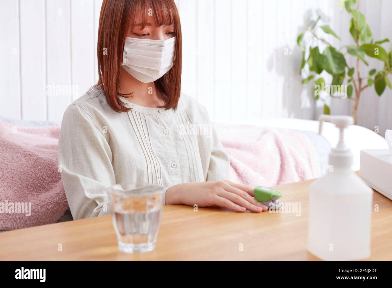 Japanese woman using pulse oximeter Stock Photo Alamy