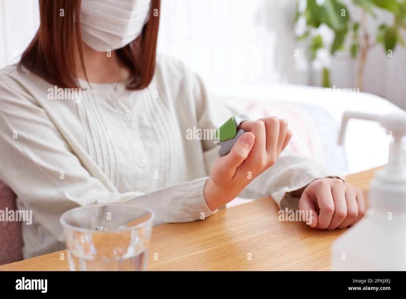 Japanese woman using pulse oximeter Stock Photo Alamy