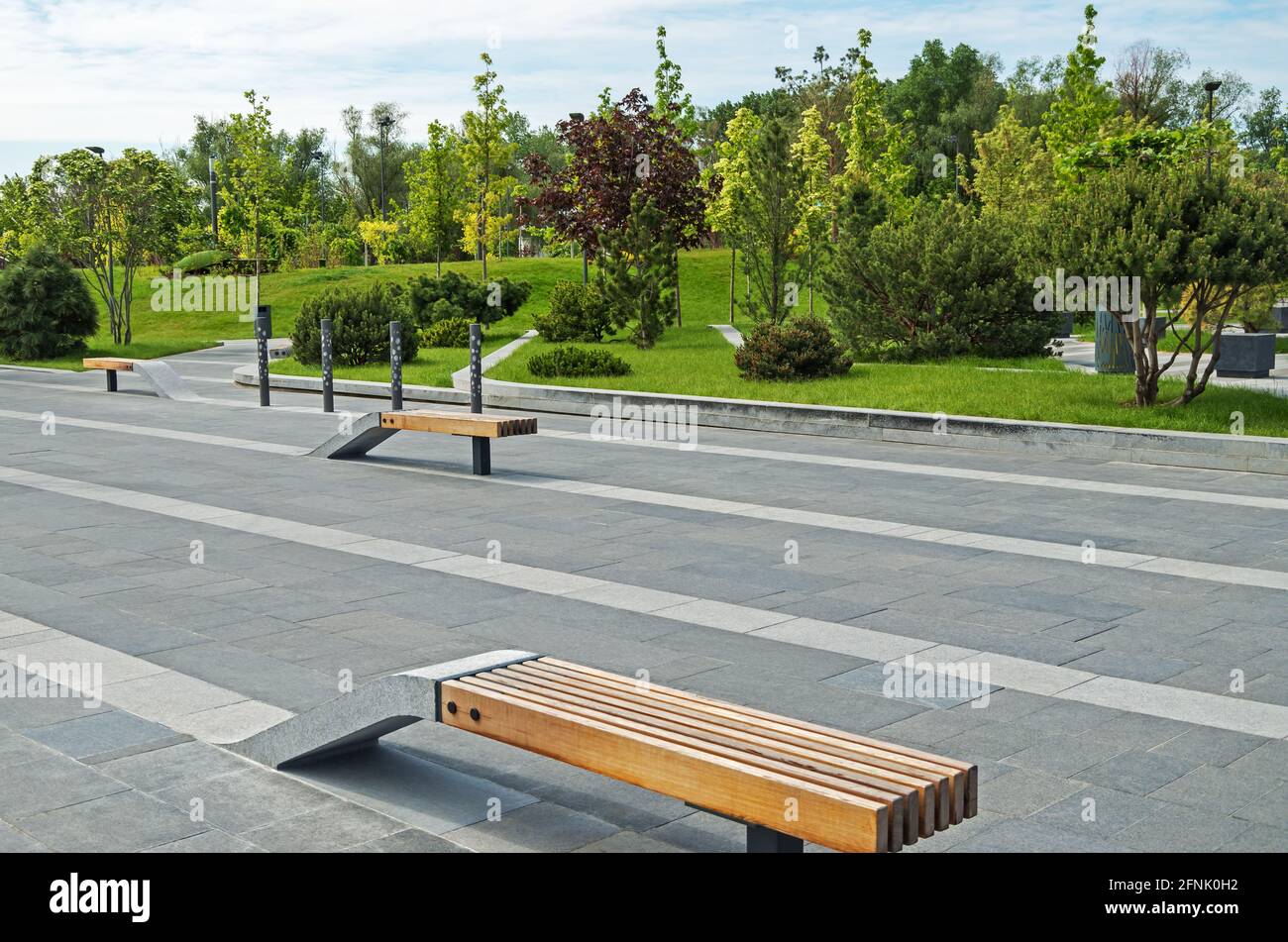 Combined wood and granite park benches in light stone on background