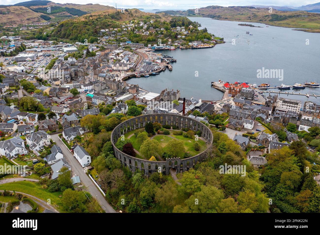 Aerial view of McCaigs tower and Oban town centre and harbour. Stock Photo