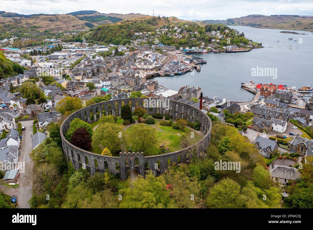 Aerial view of McCaigs tower and Oban town centre and harbour. Stock Photo