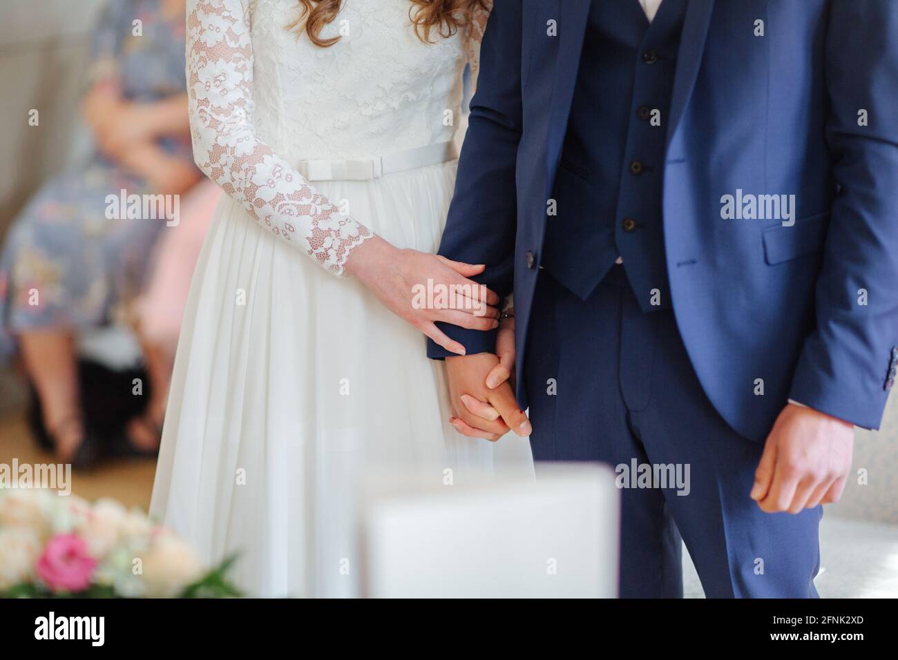 Bride and groom holding hands Stock Photo