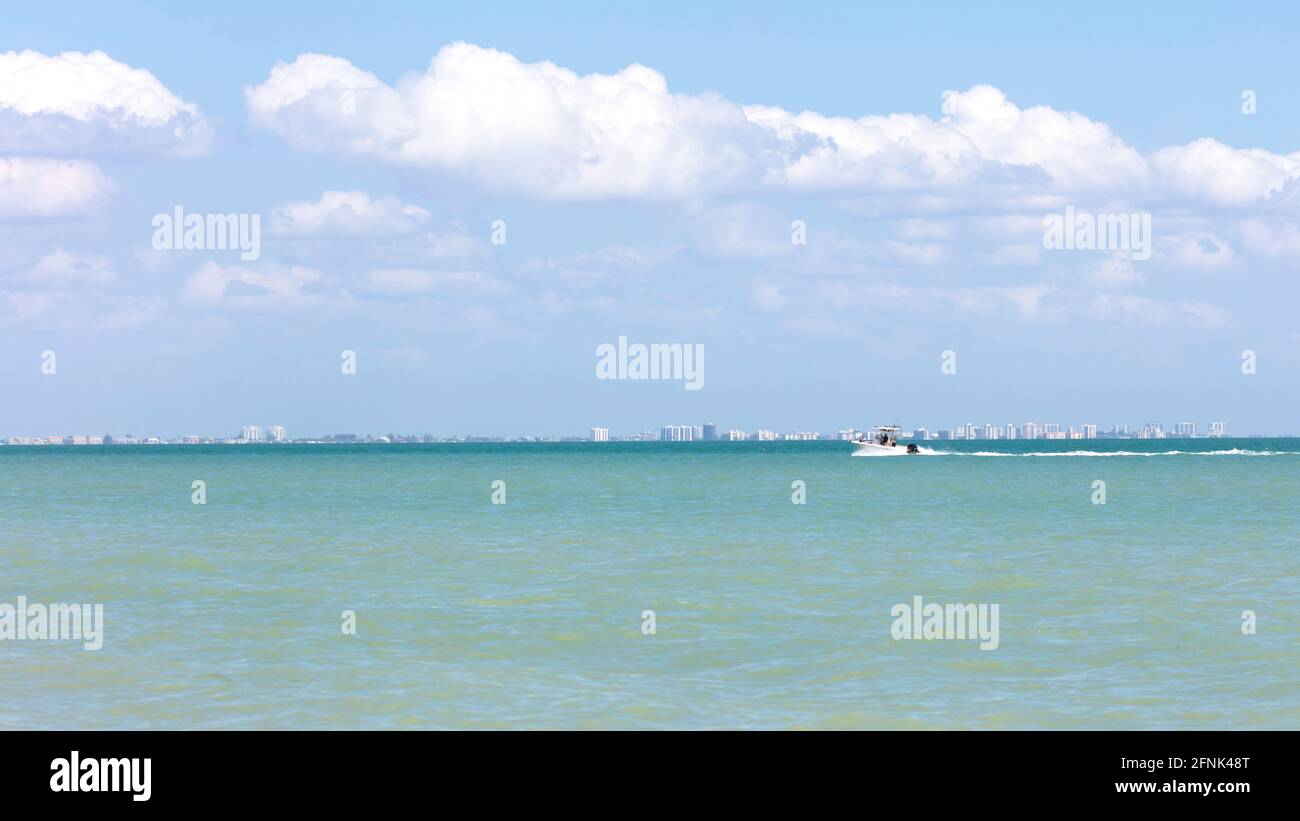 Boat rides over San Carlos Bay background Fort Myers Beach, blue sky with white clouds, Florida, USA Stock Photo