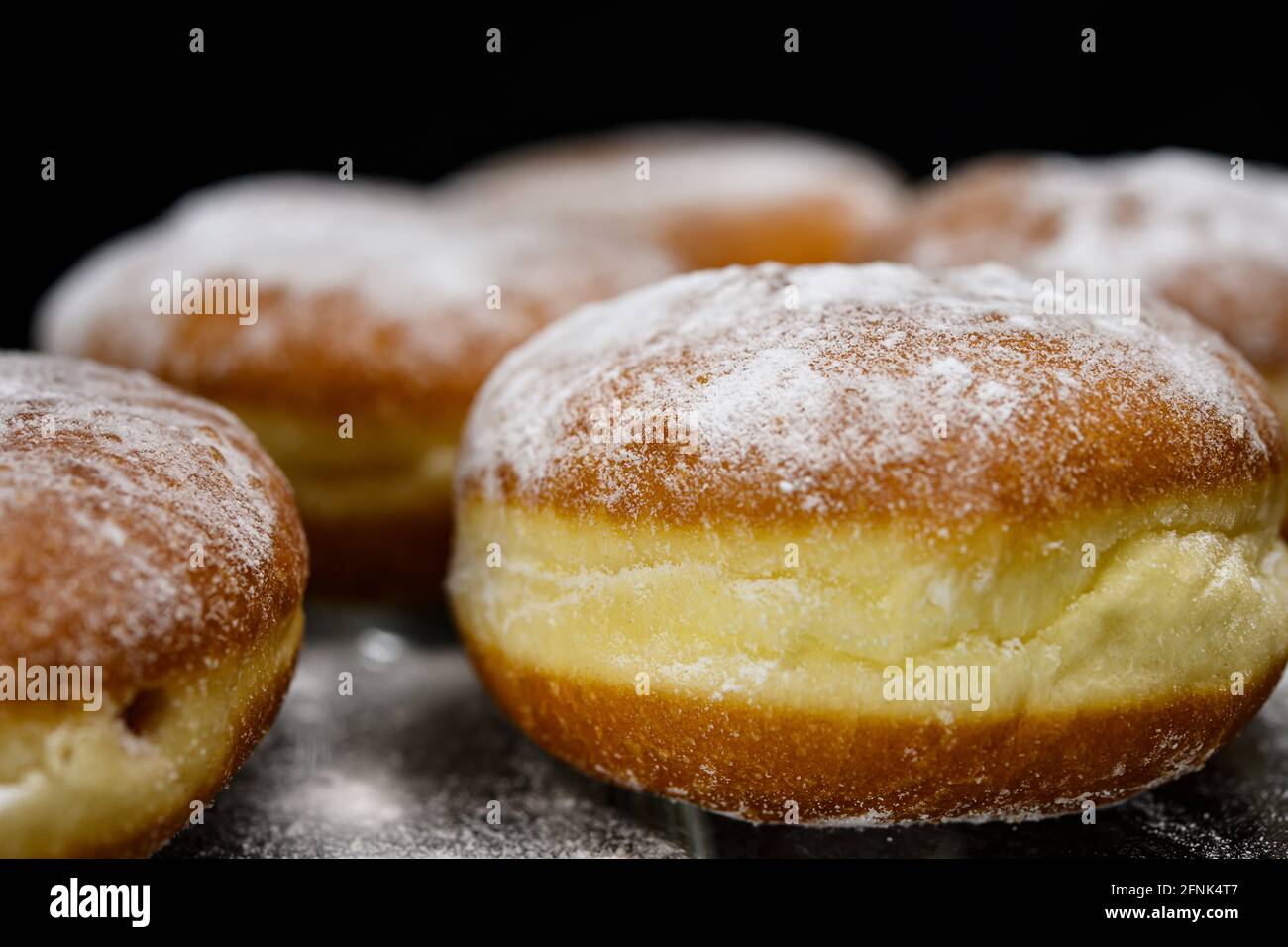 Chocolate or jelly filled donuts sprinkled with powder sugar Stock