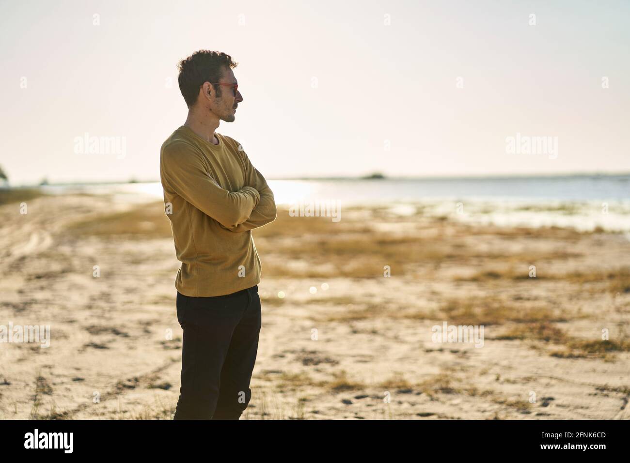 young man with sunglasses looking at the horizon Stock Photo