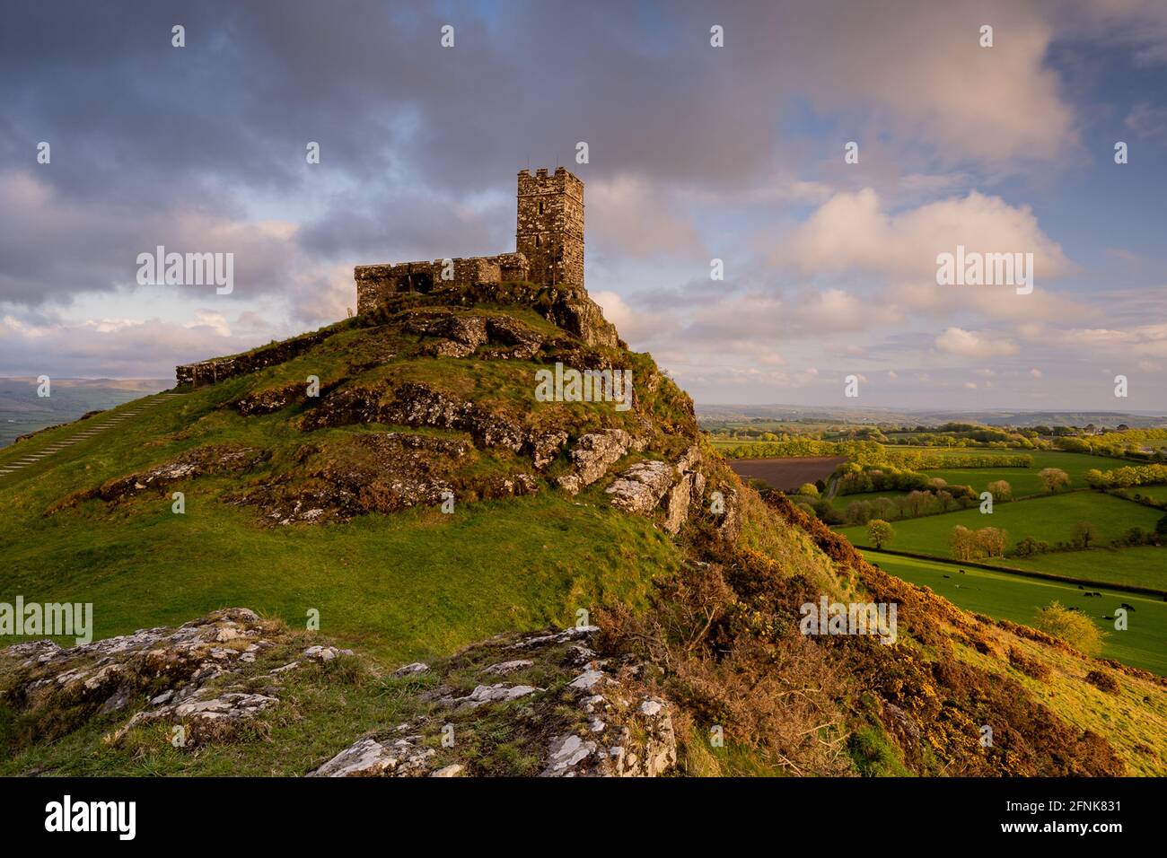 Brent Tor, Dartmoor National Park, Devon, UK. 17th May, 2021. UK Weather: Warm, golden evening light illuminates the iconic church at Brentor, Dartmoor National Park at sunset as the skies clear following two days of torrential rain. Credit: DWR/Alamy Live News Stock Photo