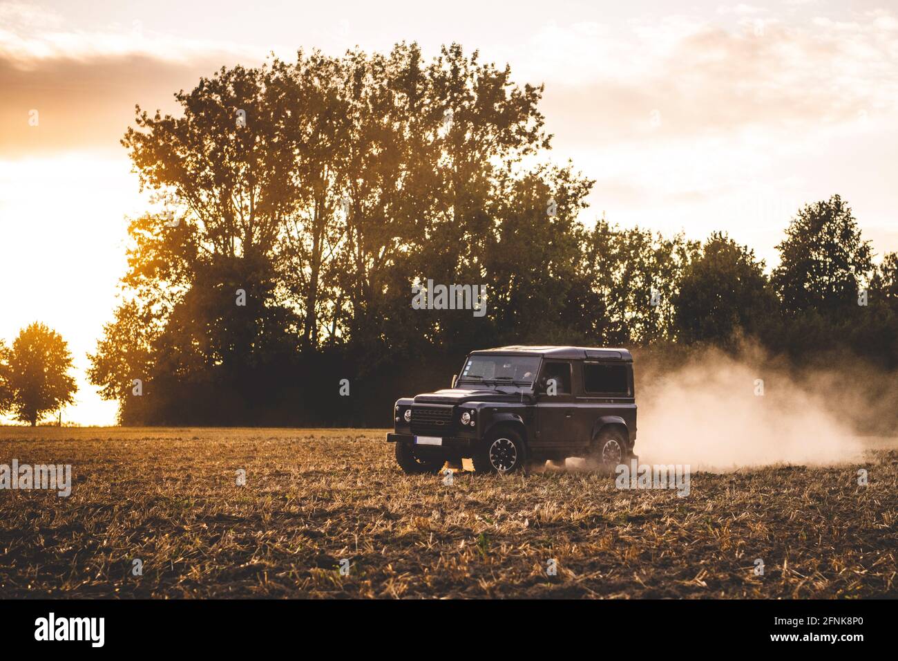 A jeep drives offroad in a field Stock Photo Alamy