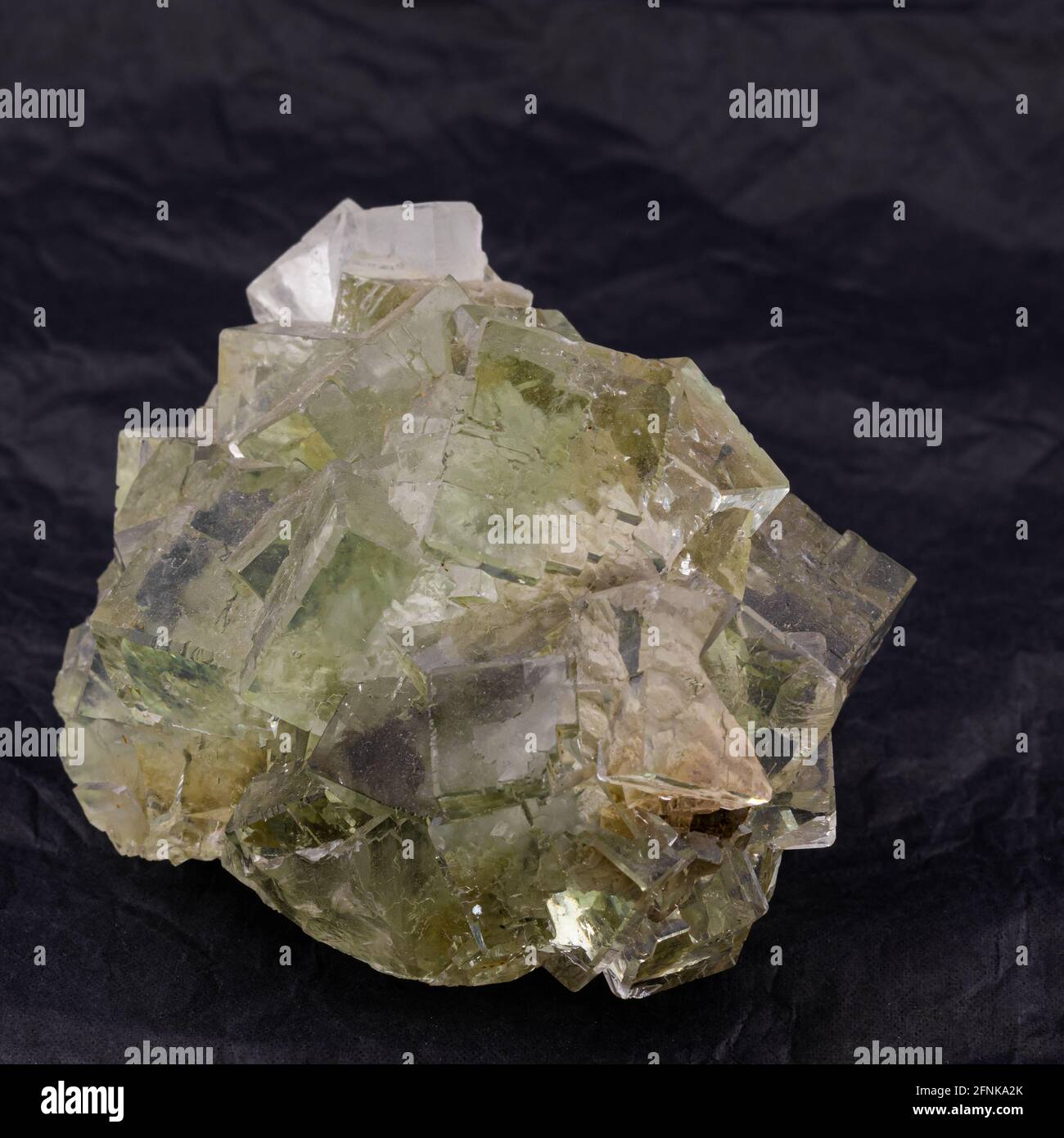 mineral specimen of green fluorite, crystals on matrix on dark background Stock Photo