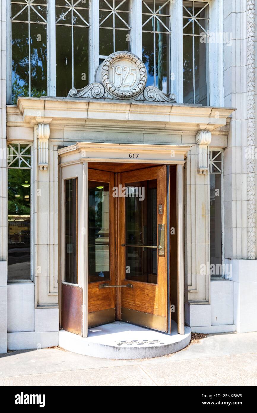 CHATTANOOGA, TN, USA-7 MAY 2021: A vintage oak revolving door in a building dated 1925. Stock Photo