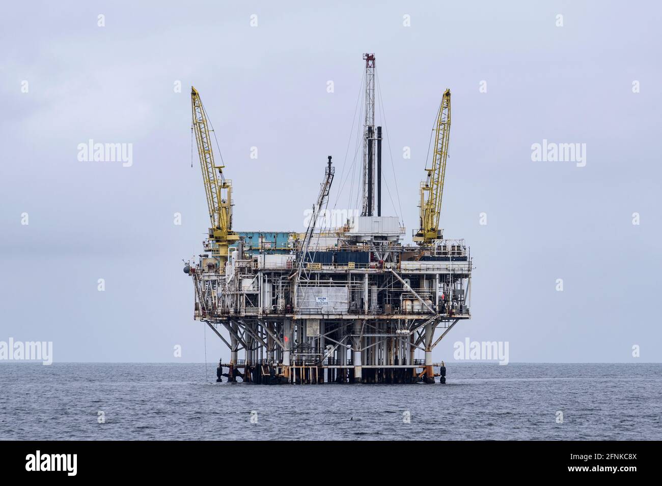 Ventura, California, USA - May 11, 2021:  Calm pacific ocean conditions at offshore oil drilling platform Gilda near the Channel Islands National Park Stock Photo