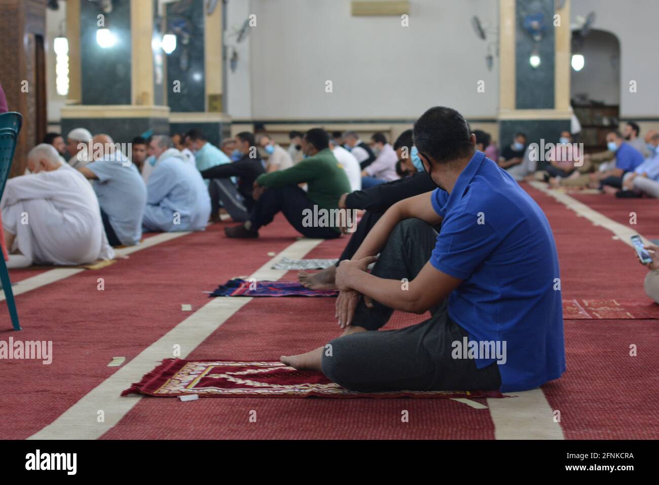 Muslims perform first Eid Al-Fitr prayers at mosques in Covid-19 pandemic era under the recent anti-coronavirus safety measures in large-sized mosques Stock Photo