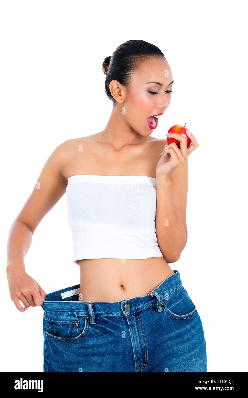 Young Asian woman losing weight by living healthy and eating fruit Stock Photo