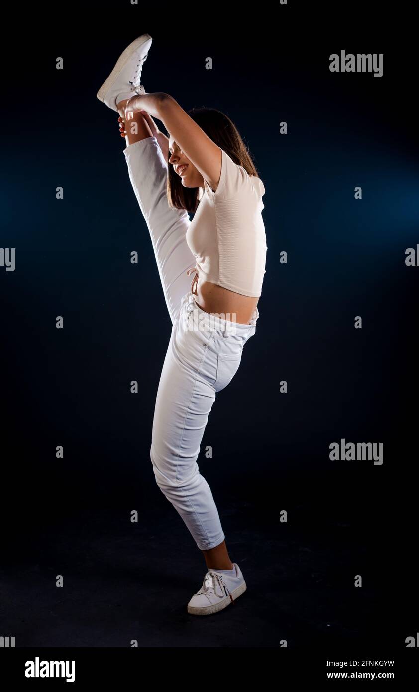 Attractive young slim muscular woman doing side plank Stock Photo - Alamy