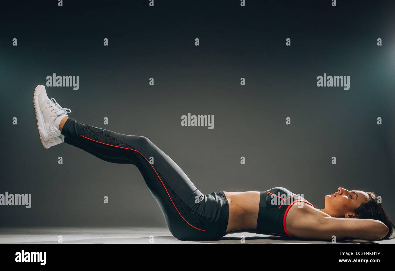 Warming up before training. Side view of young beautiful young woman in ...