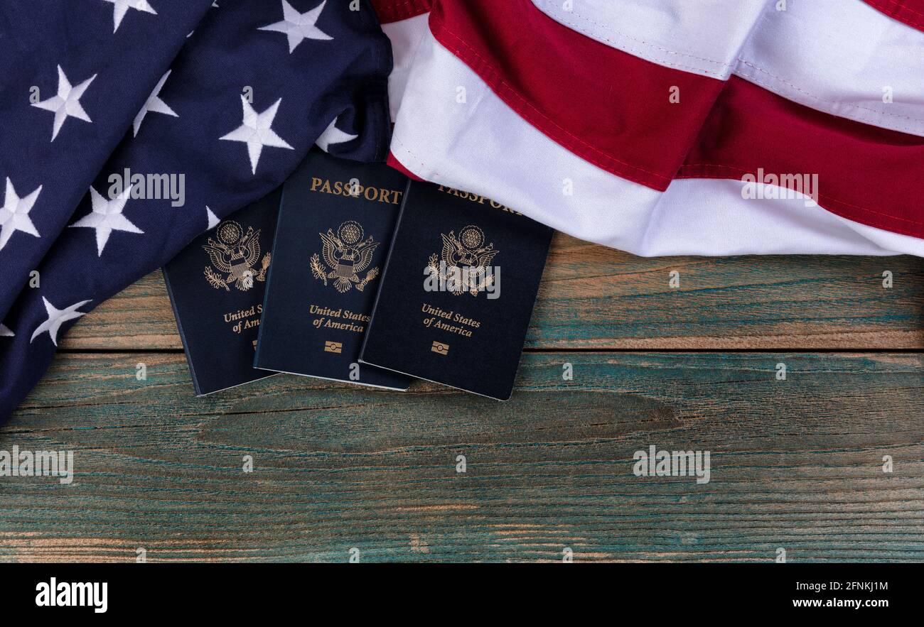 United States flag with US passport books on vintage wooden planks for travel concept Stock Photo