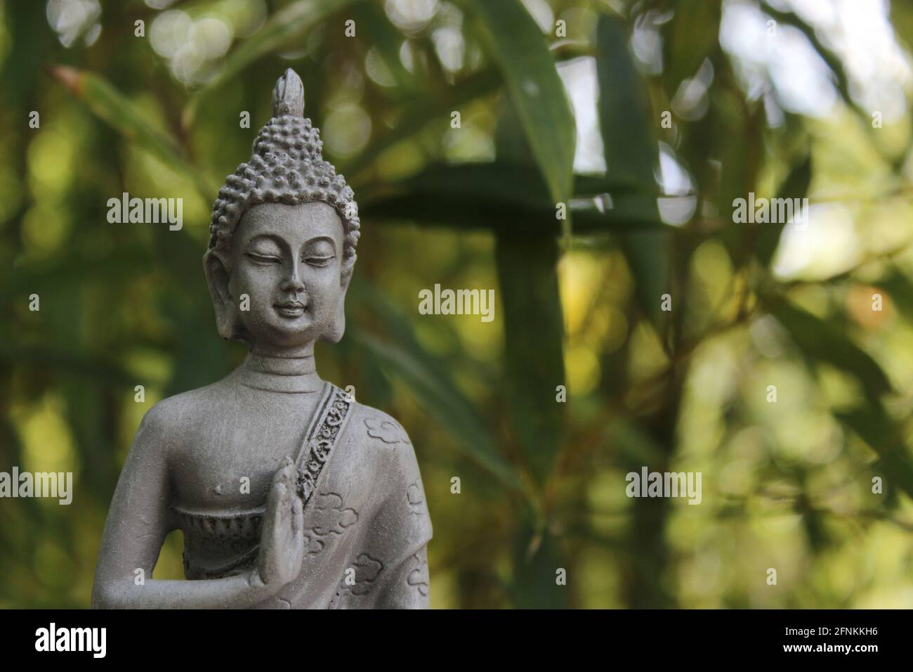 Buddha Statue Outdoors in Garden With Blurred Background Stock Photo