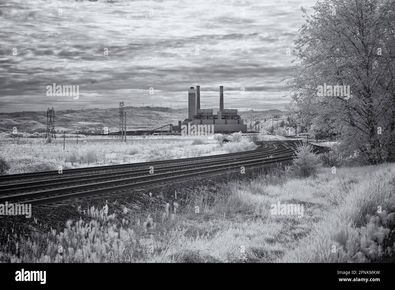 The Centralia Steam Plant electric generating station iwith its wind turbine replacements in teh background. Stock Photo
