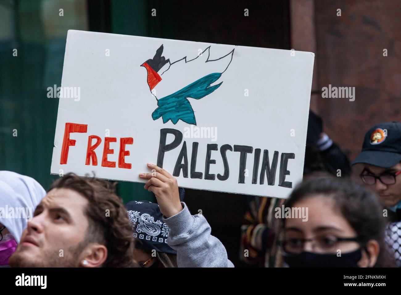 Dayton, United States. 17th May, 2021. Pro-Palestinian demonstrator holds a Free Palestine sign. Demonstrators meet at Courthouse Square in Dayton, Ohio to rally and march against Israel's airstrike on Gaza and the occupation of Palestine. According to the Hamas-run health ministry, the overall death toll stands around 200, which include 59 children and 35 women, with at least 1,305 injured. (Photo by Stephen Zenner/SOPA Images/Sipa USA) Credit: Sipa USA/Alamy Live News Stock Photo
