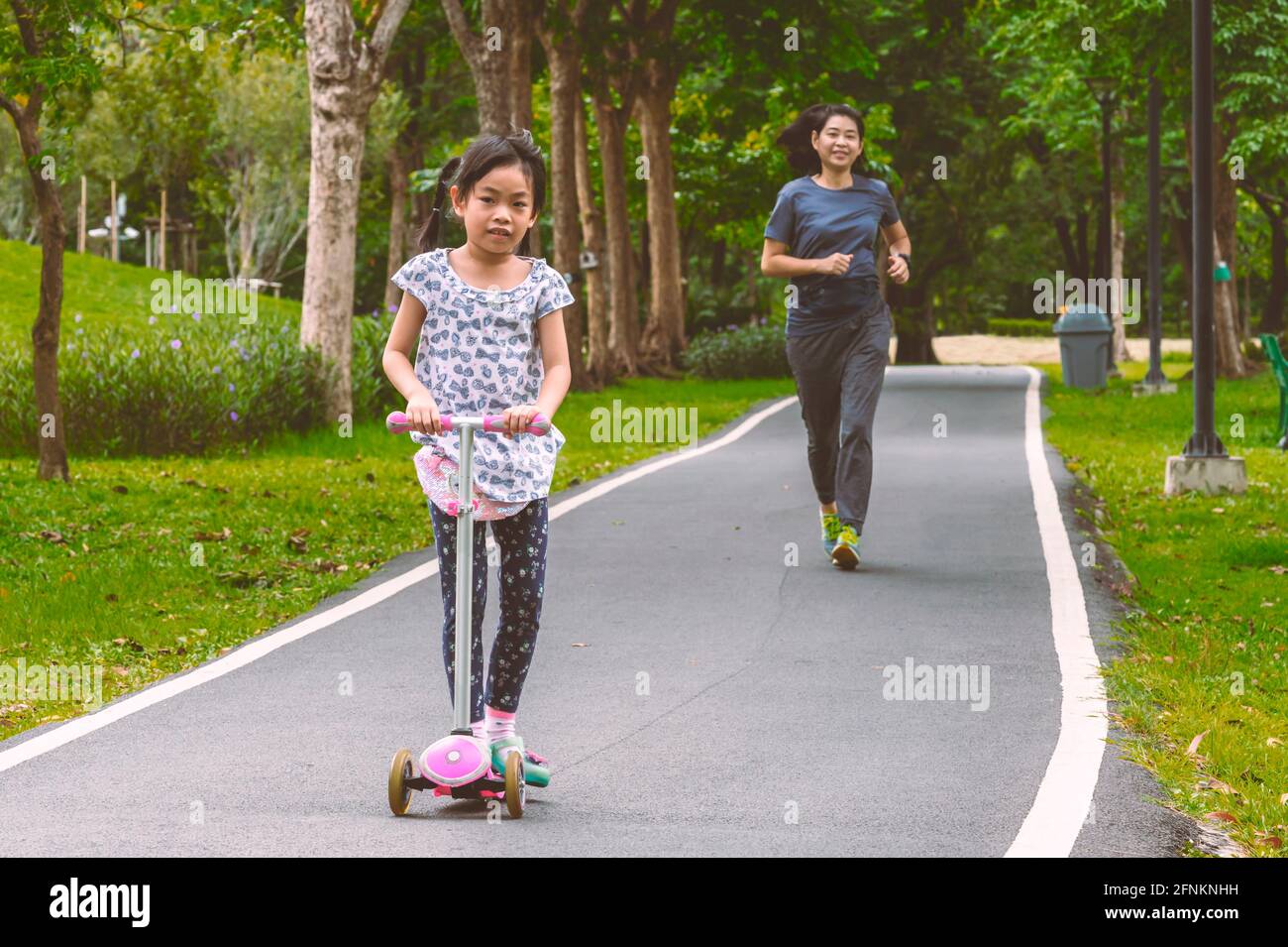 Beautiful childhood, together with parent in park, exercise with mother