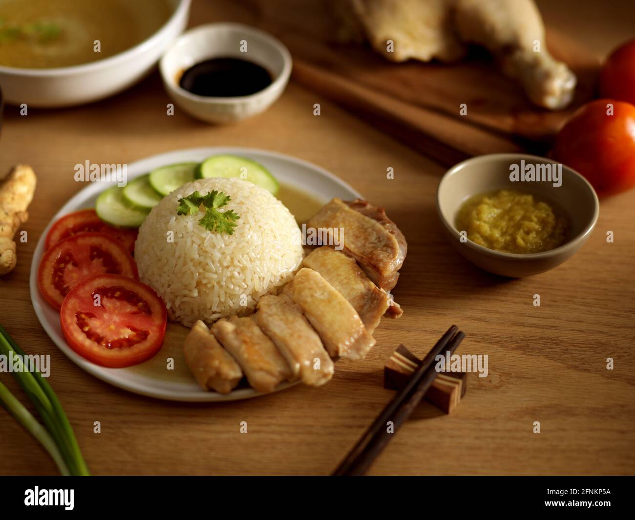 Hainanese chicken rice (steamed chicken rice) with sauces and veggies ...