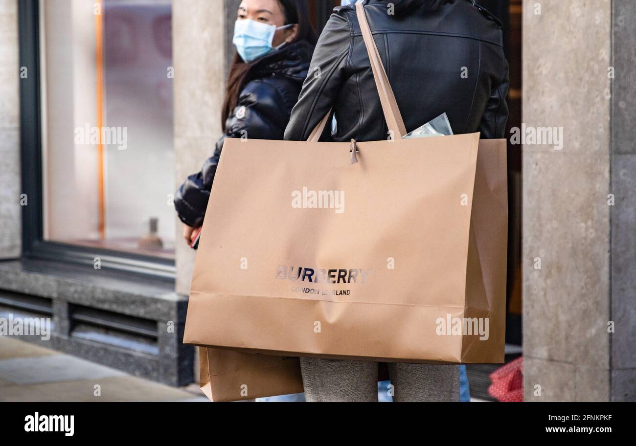 London, UK. 17th May, 2021. Shopper seen carry Burberry merchandiser bag.  The Prime Minister announced that England can proceed to Stage Three on May  17, 2021. Most shops can reopen including indoor.