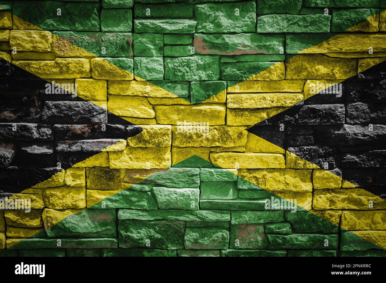 National flag of Jamaica on stone wall background.The concept of