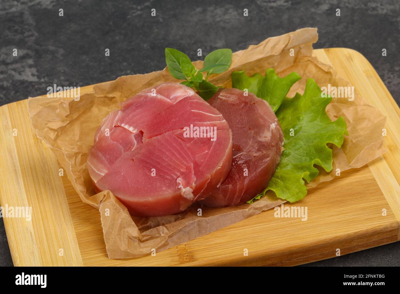 Raw tuna round steak ready for grill Stock Photo - Alamy
