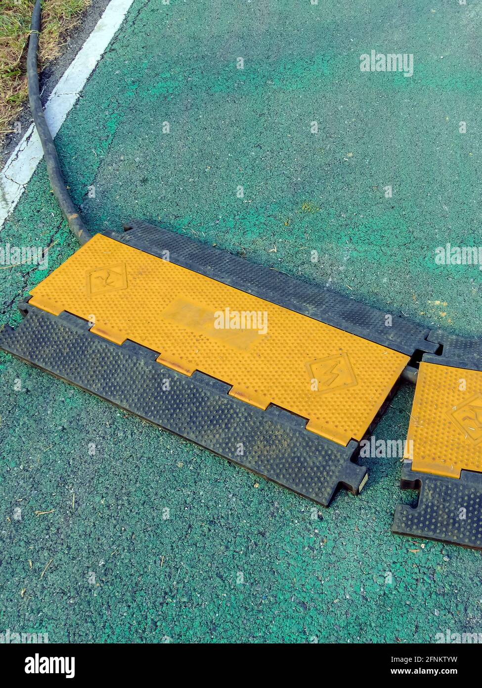 Black and yellow heavy plastic covers for people and vehicle to cross