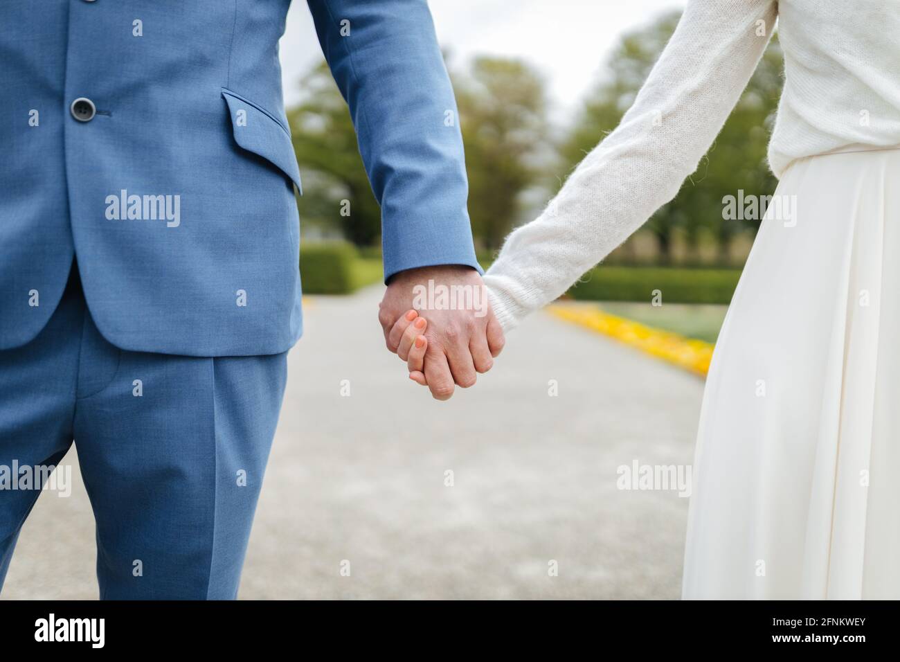 Bride and groom holding hands Stock Photo